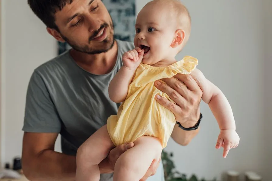 A father holding his baby daughter.